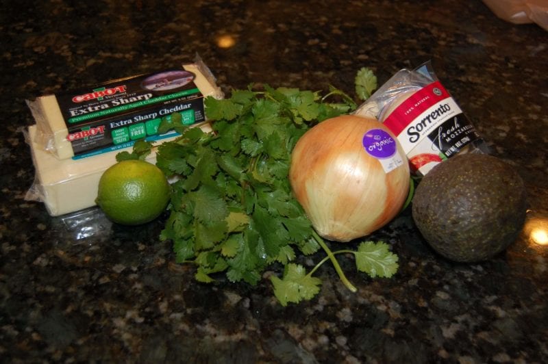 Groceries from Harris Teeter that include cheese and produce. 