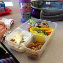mixing yogurt and granola in a school lunch container