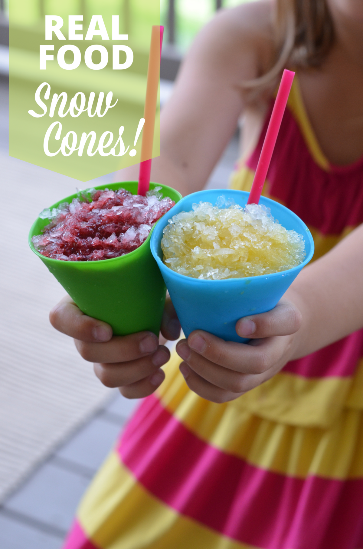Little girl holding real food snow cones in bright colored cups and straws.