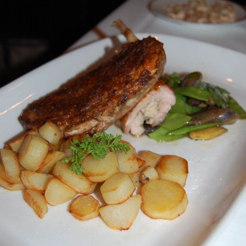 Moroccan Chicken with roasted potatoes and green beans  on a plate served at Gotham Bar & Grill in NYC.  