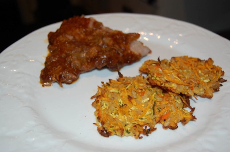 Pork ribs made in the slow cooker and brown rice patties on a plate. 