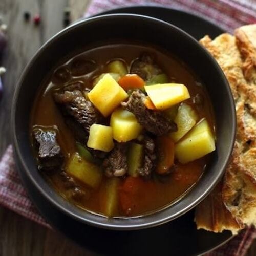 Irish stew in a bowl with bread.