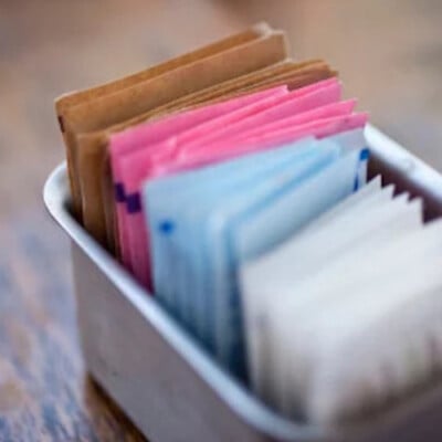 sugar packets in a tin